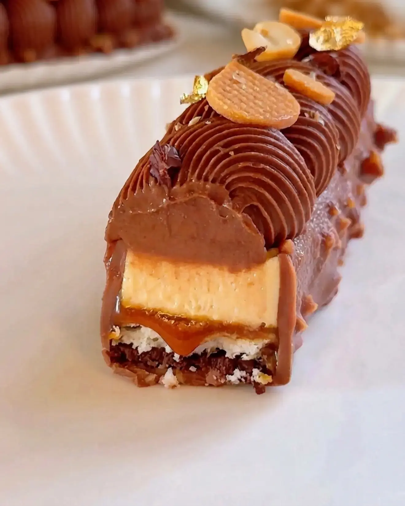 Peanut Butter Chocolate Caramel Bar: A Layered Pastry Dessert 13 Peanut Butter Chocolate Caramel Bar, With chocolate feuilletine, dacquoise, salted caramel, peanut butter mousse, chocolate whipped ganache, and rocher glaze