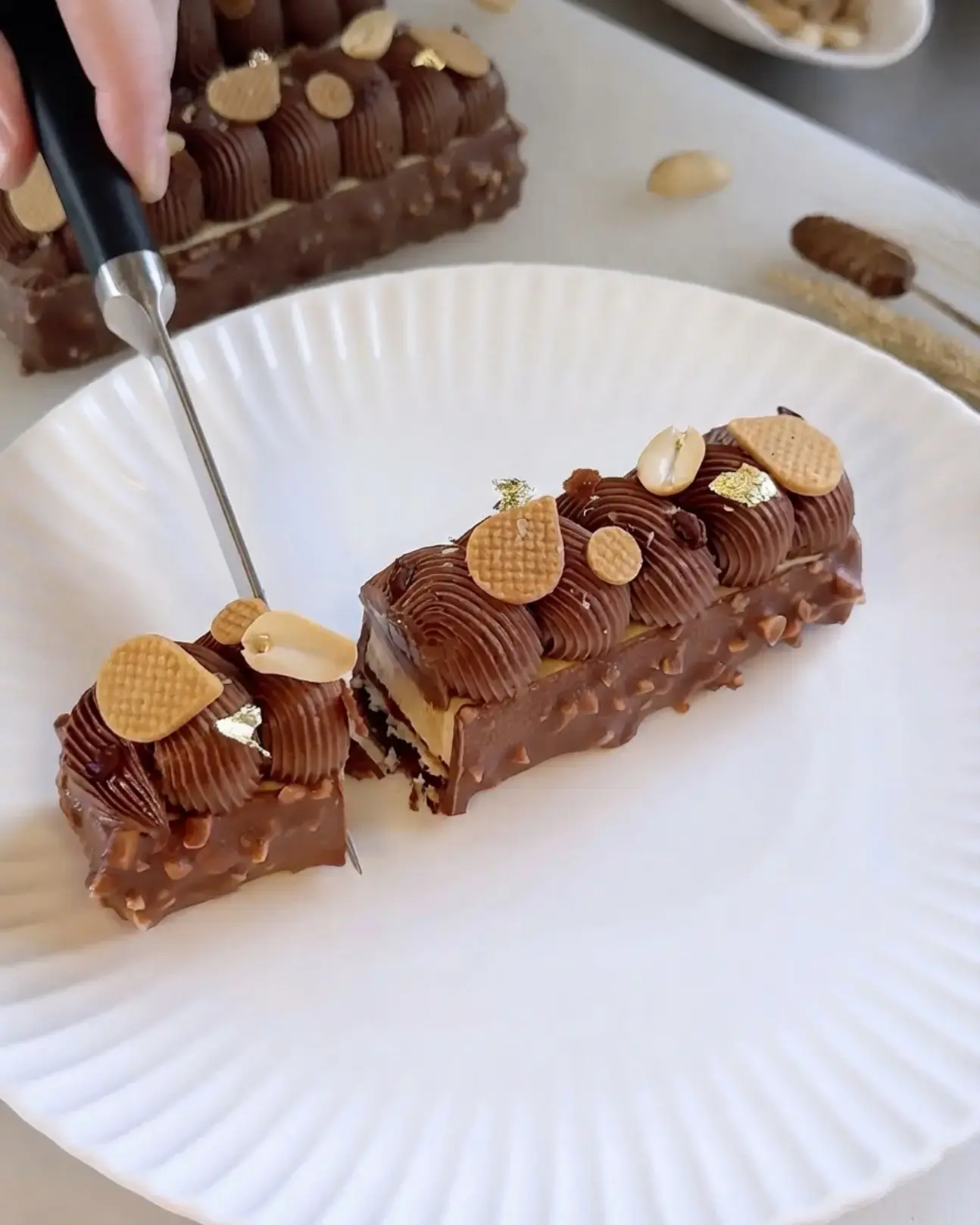 Peanut Butter Chocolate Caramel Bar: A Layered Pastry Dessert 14 Peanut Butter Chocolate Caramel Bar, With chocolate feuilletine, dacquoise, salted caramel, peanut butter mousse, chocolate whipped ganache, and rocher glaze